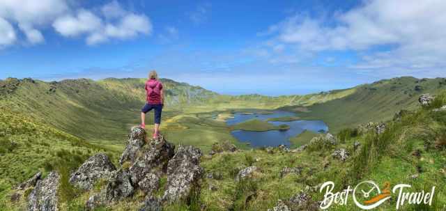 A woman in front of Corvo Caldera on a sunny day