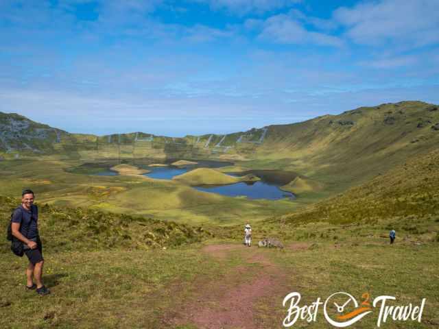 A hiker in the Corvo Caldera on a sunny day with blue sky.