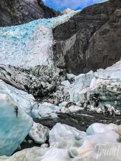 The Franz Josef Glacier with a blue sky