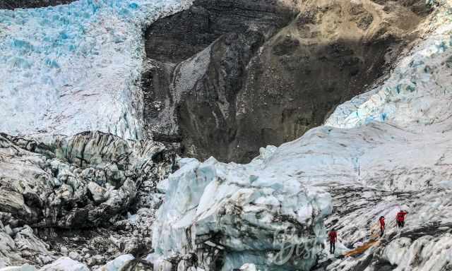 The guides digging a route through the glacier ice for tourists