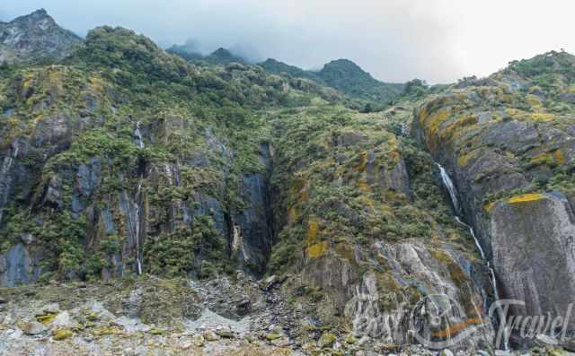 A huge wall and waterfalls along the path to Franz Josef Glacier