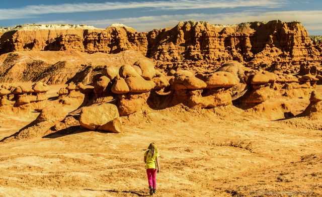 A girl is hiking in the desert of Goblin