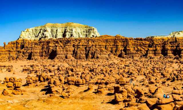 Panorama of Goblin with visitors hiking between the hoodoos