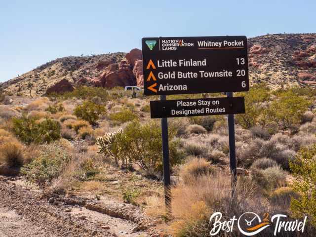 Road sign wit mileage for Little Finland and the Ghost Town