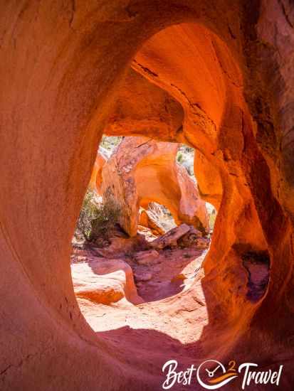 Looking through a shimmering orange hole in a rock