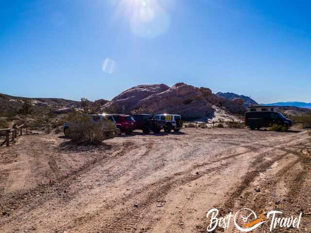 Several 4 WD vehicles and ATVs at the trailhead.
