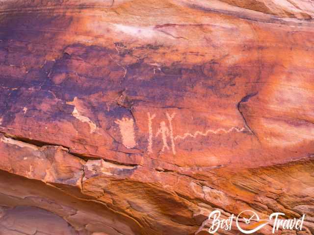 Petroglyphs on an orange reddish rock