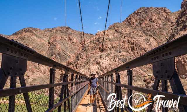 A hiker on Black Bridge above the Colorado