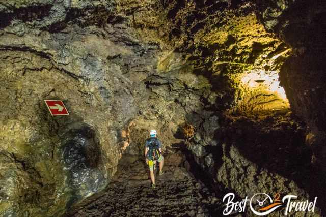 A visitor inside of Gruta do Natal wearing a helmet