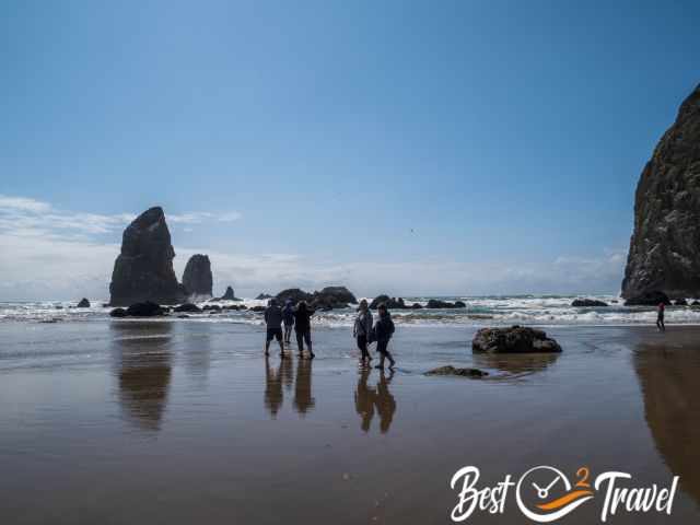 The outgoing tide and visitors walking on Cannon Beach