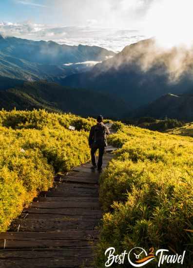 A híker walking the path down after watching the sunrise