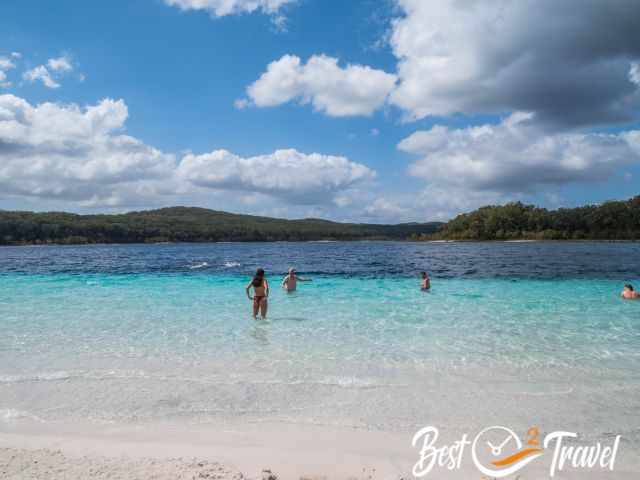 The turquois-blue water and the white sand beach