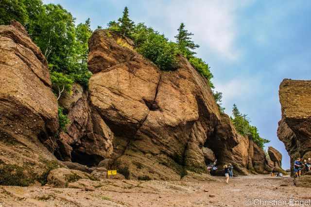 The Hopewell Rocks and visitors close to the shore.