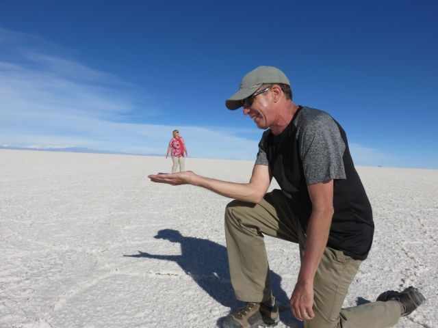 The illusion of a small women standing on the hand of her husband