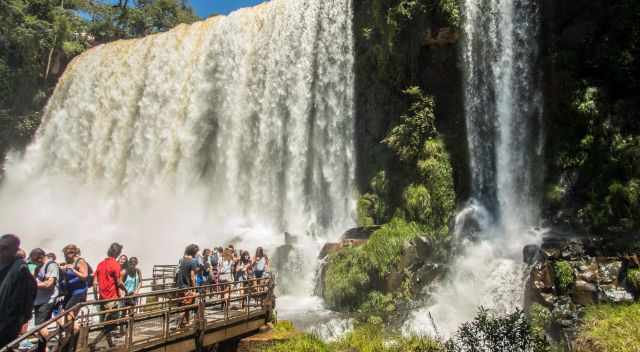 Crowds on a boardwalk at one of the many waterfalls