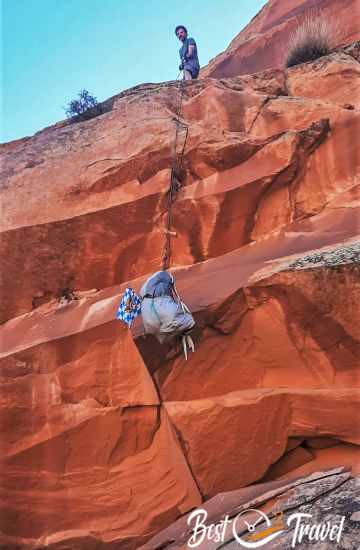 A hiker is abseiling the backpack from high elevation