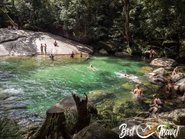 People swimming at the bottom of Josephine Falls in the pool-