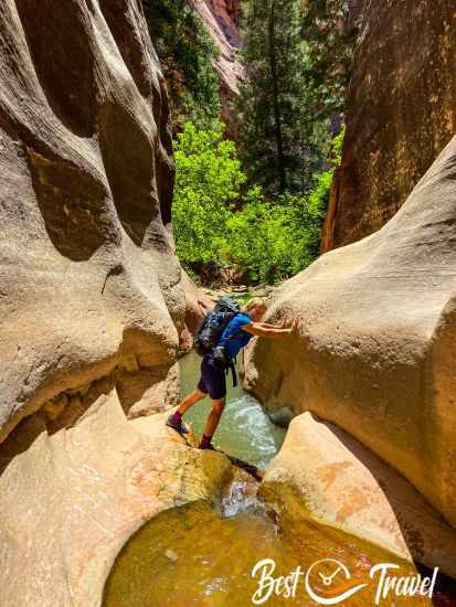 A hiker at the end of the gorge trail trying to circumvence the deep pool.