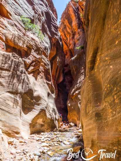 A hiker disappearing behind the next corner and wall