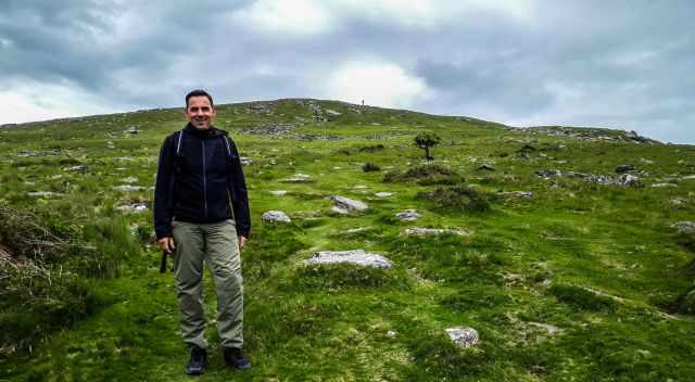 Widgery Cross in the distance and a hiker in front