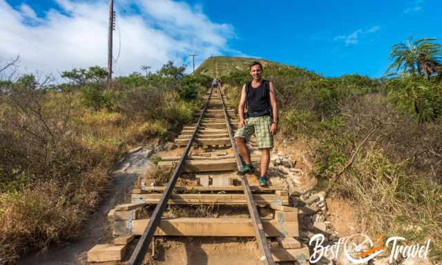 A hiker sweating in the afternoon sun on the railway track