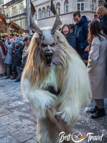 A costume with white fur, white hair and a black tongue.