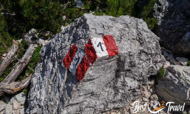 A rock marked with the trail symbol and the number 1