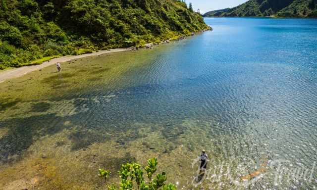 Two men standing in Lagoa do Fogo