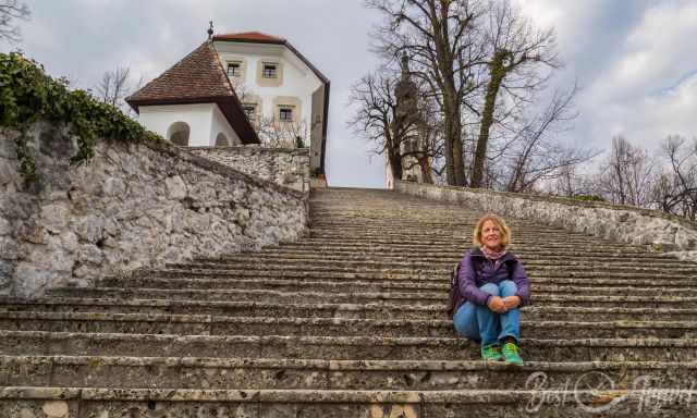 A woman sitting on the staircase, the 99 steps to the church