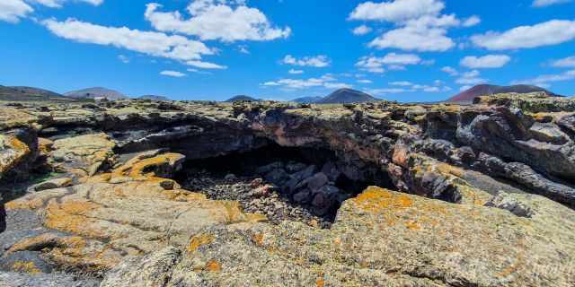Broken up earth with huge holes in the lava field