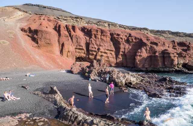 Beach next to Charco de los Clicos with people sunbathing