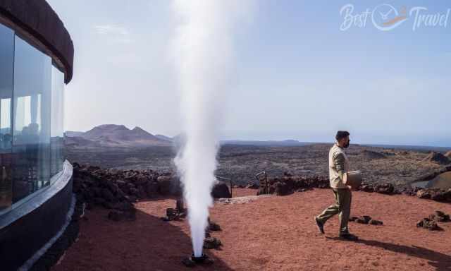 Water is spit out of an artificial geyser