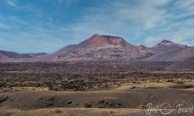 Spectacular red volcano and black rocky landscape in Timanfaya