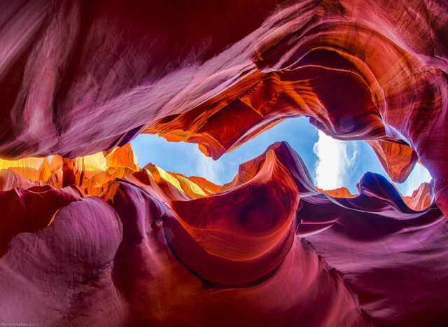 Read, purple, and orange sandstone and view up to the sky