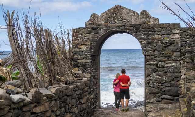 Ruins of St. George - Couple standing in an open door just in front of the sea