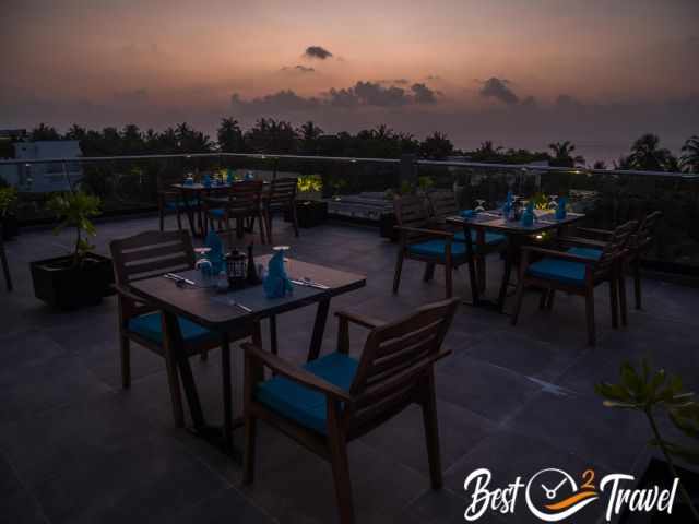 A roof top restaurant at sunset.