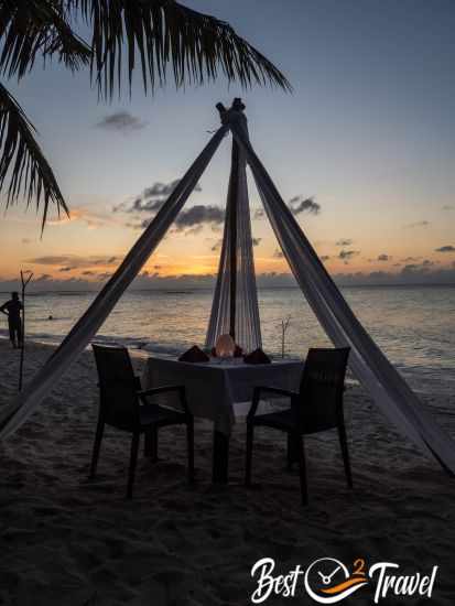 A romantic dinner at the beach at sunset.