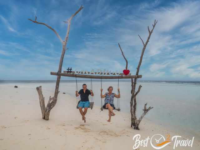 A couple on the Omadhoo Swing in the sea.