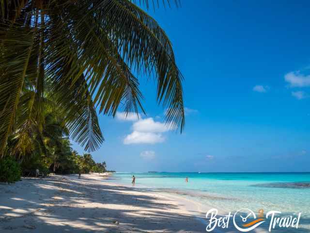 Sun bathers at Dhigurah Beach in the shade and sea