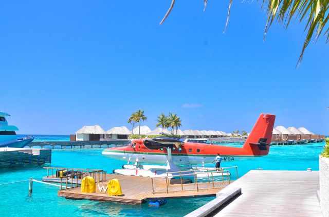 A seaplane at the jetty of a luxus resort