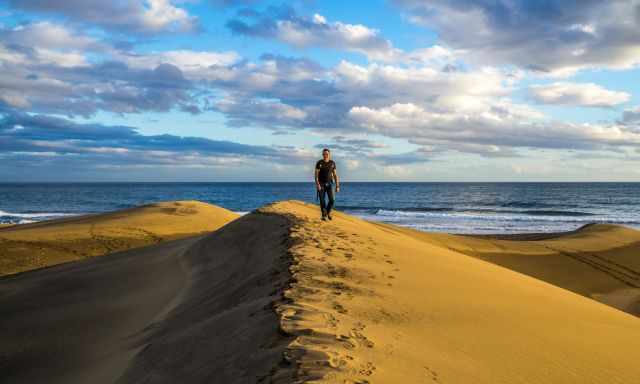 A man walking at Maspalomas Beach and Dunes