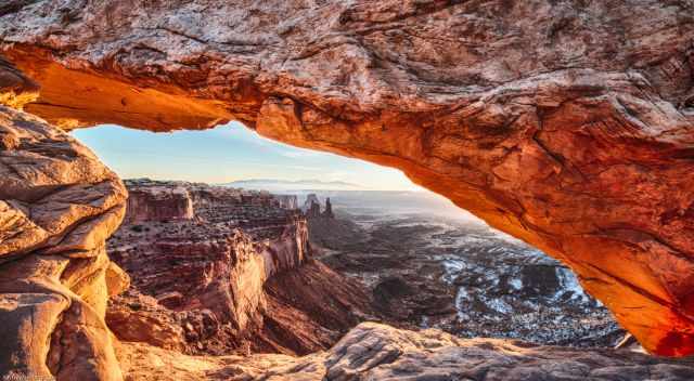 Mesa Arch with snow in winter at sunrise