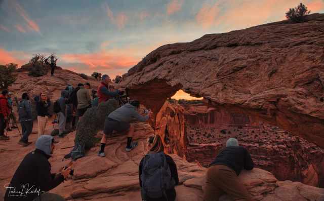 Mesa Arch full of photographers at sunrise