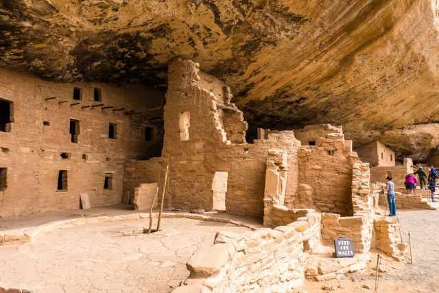 Visitors and a ranger in one of the cliff dwellings