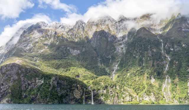 Lots of waterfalls in Milford Sound with a clear blue sky