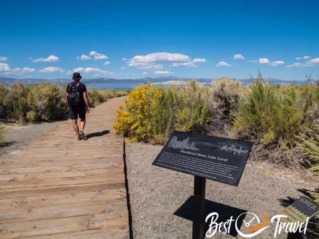 A hiker on a boardwalk at Mono Lake