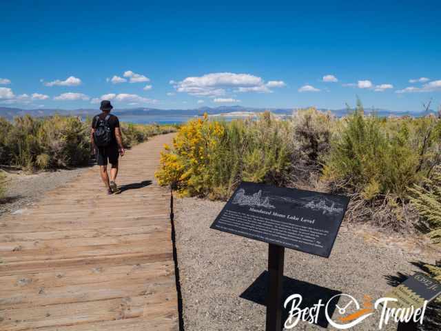 A hiker on a boardwalk at Mono Lake