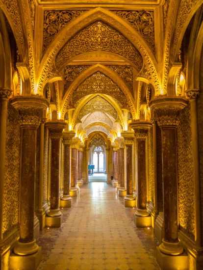 The long corridor with pillars and a window at the end.