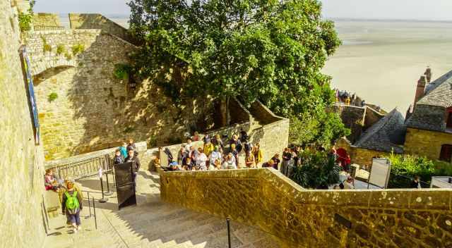 Tourists queuing to access Mont Saint Michel