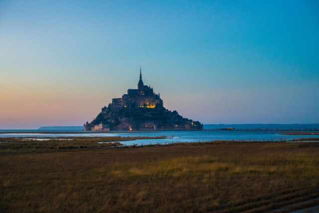 Mont Saint Michel illuminated view from the distance.